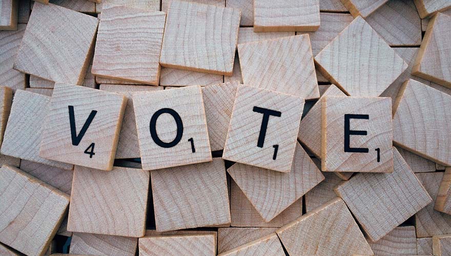 Scrabble pieces that say "vote"